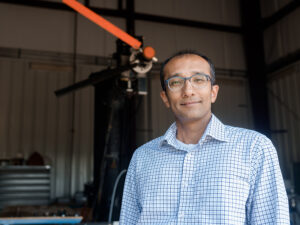 Jayant Sirohi standing inside large warehouse lab