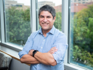 Noel Clemens standing in front of windows in office
